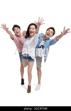 Happy young friends reaching out hands Stock Photo