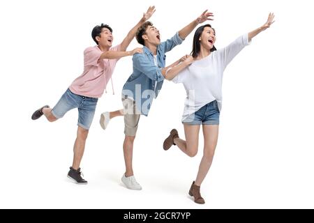 Happy young friends reaching out hands Stock Photo