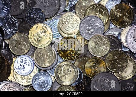 Close up of Malaysian ringgit cents. The coins of the Malaysian currency. Bank Negara issue 5, 10, 20 and 50 sens. In the center a golden fifty cent c Stock Photo