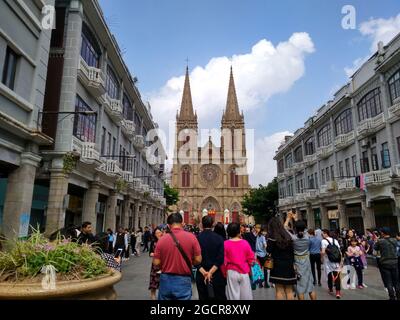 The beautiful Sacred Heart Cathedral in Guangzhou a family of three centered with the entrance Stock Photo