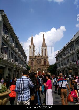 beautiful Sacred Heart Cathedral in Guangzhou packed with tourists angelic cross steeples Stock Photo