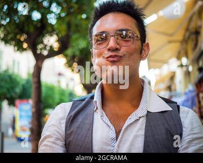 Ethnic man with funny face on street Stock Photo