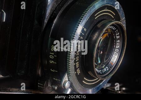 Leipzig, Saxonia, Germany - October 1, 2020: Old scratched and dusty photo camera, with foldable original Carl Zeiss Lens. Camera Lense 50mm antique Stock Photo