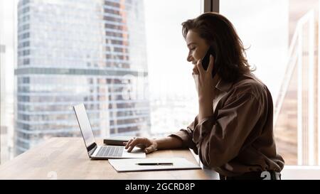 Happy confident businesswoman working in office, talking, Stock Photo