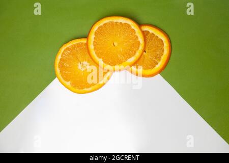 Slices of orange on two color background Stock Photo