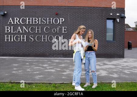 Faith Bryant (left) and Abbie Hollis at Archbishop Blanch School in Liverpool, as students receive their A-Level results. Picture date: Tuesday August 10, 2021. Stock Photo