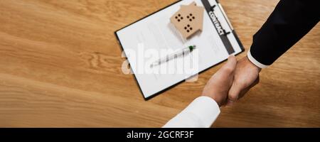 success and successful negotiation    in business, top view of handshake and shake hand of two businessmen with contraction of property Stock Photo
