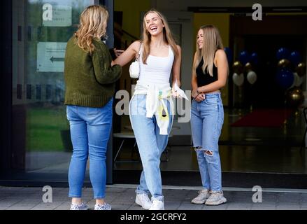 Faith Bryant (centre) and Abbie Hollis (right) at Archbishop Blanch School in Liverpool, as students receive their A-Level results. Picture date: Tuesday August 10, 2021. Stock Photo
