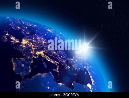 Illustration of the sunrise over Planet Earth, European city lights visible. Energy consumption concept. Some elements of the image furnished by NASA. Stock Photo