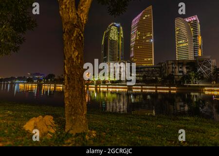 Putrajaya, Malaysia - 2021, February 26: Time lapse close to the ground with the green grass. View to office buildings near the Putra lake. Stock Photo
