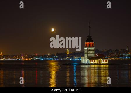 Galata Tower. Galata Tower with full moon at moonset. Istanbul story ...