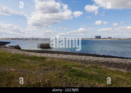 Hartlepool Nuclear Power Station and decommisioned oil rigs at Seaton Port as viewed from South Gare,Redcar,England,UK Stock Photo