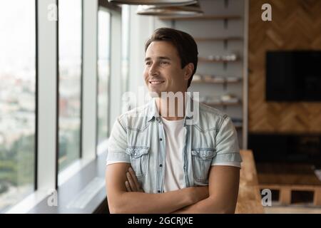 Portrait of happy pensive businessman in casual looking at window Stock Photo