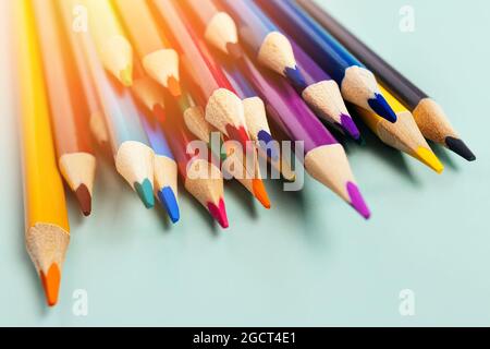 Sharp colored pencils for drawing lie on the table. Accessories for creativity and artists. background. Minimalism and aesthetics. Stock Photo