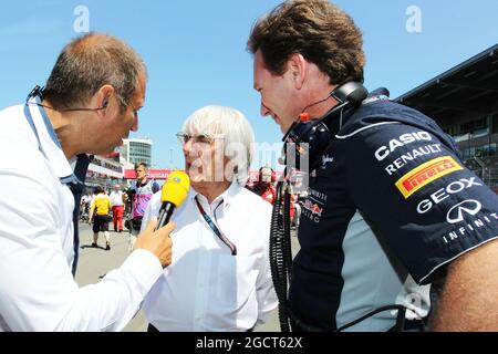 (L to R): Kai Ebel (GER) RTL TV Presenter with Bernie Ecclestone (GBR) CEO Formula One Group (FOM) and Christian Horner (GBR) Red Bull Racing Team Principal. German Grand Prix, Sunday 7th July 2013. Nurburgring, Germany. Stock Photo