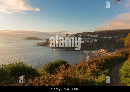 Warm summer Sunrise in Looe Bay on to the beach at Looe on the Cornish coast Stock Photo