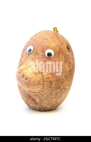 Potato with googly eyes (Solanum tuberosum) on a white background Stock Photo