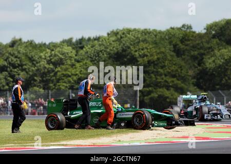 Marcus Ericsson (SWE) Caterham CT05 spins and stops during FP1, passed by Nico Rosberg (GER) Mercedes AMG F1 W05. British Grand Prix, Friday 4th July 2014. Silverstone, England. Stock Photo