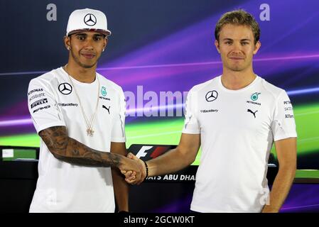 (L to R): Lewis Hamilton (GBR) Mercedes AMG F1 with team mate and fellow World Championship contender Nico Rosberg (GER) Mercedes AMG F1 in the FIA Press Conference. Abu Dhabi Grand Prix, Thursday 20th November 2014. Yas Marina Circuit, Abu Dhabi, UAE. Stock Photo