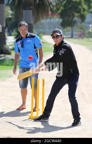 Sergio Perez (MEX) Sahara Force India F1 Team (Right) plays cricket in Albert Park with Brad Hodge (AUS) (Left) International Cricket Player. Australian Grand Prix, Tuesday 10th March 2015. Albert Park, Melbourne, Australia. Stock Photo