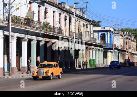 HAVANA, CUBA - FEBRUARY 24, 2011: People drive old car in Havana. Cuba has one of the lowest car-per-capita rates (38 per 1000 people in 2008). Stock Photo
