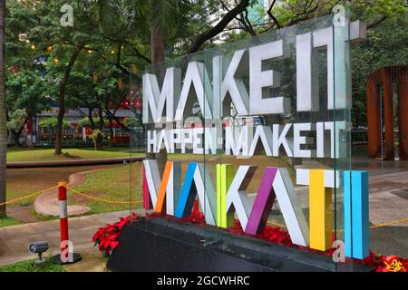 MANILA, PHILIPPINES - DECEMBER 7, 2017: Make It Happen, Make It Makati sign at Ayala Triangle, Makati, Metro Manila. Metro Manila is one of the bigges Stock Photo