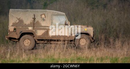 British Army Land Rover Defender light utility vehicle on exercise Salisbury Plain, Wiltshire, UK Stock Photo