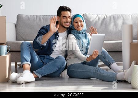 Happy middle-eastern family having online party with friends Stock Photo