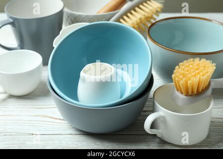 Concept of dish washing on white wooden table Stock Photo