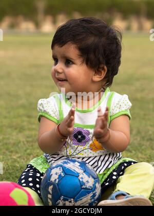 cute indian baby girl playing in the park.