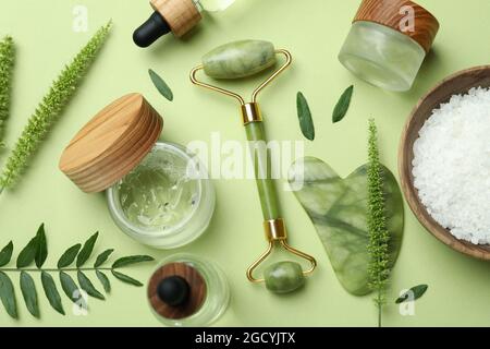 Skin care beauty concept with face roller on green background Stock Photo