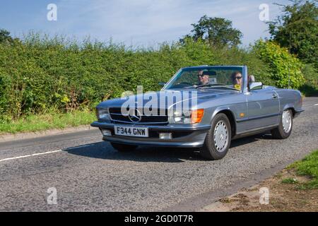 1988 80s grey Mercedes Benz 300 SL 2962cc petrol cabrio en-route to Capesthorne Hall classic July car show, Cheshire, UK Stock Photo