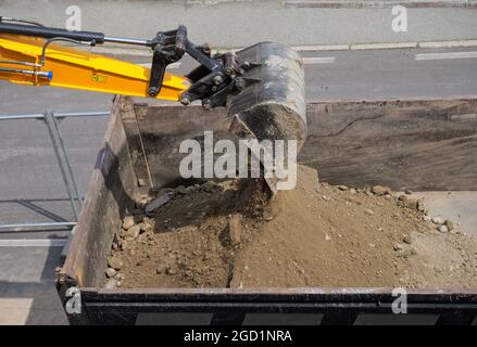 excavator loading dirt into dump truck Stock Photo