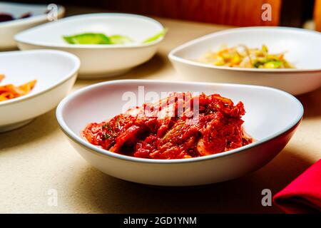 Korean signature Kimchi Stew in a hot ceramic pot served with other side  dishes Stock Photo - Alamy