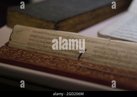 Pages of ancient handwritten book, probably old Khmer language, made of palm leaf, on exposition in museum in Thailand Stock Photo