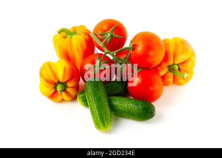 Ripe vegetables isolated on white. Tomato, sweet paprika and cucumbers close-up. Stock Photo