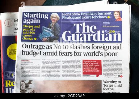 'Outrage as No 10 slashes foreign aid budget amid fears for world's poor' Guardian newspaper front page headline on 14 July 2021 London England UK Stock Photo