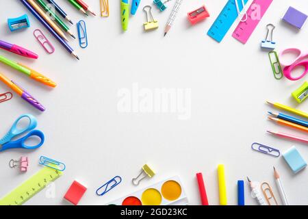 School supples frame on white background. Flat lay, top view colorful stationery. Back to school banner mockup. Stock Photo