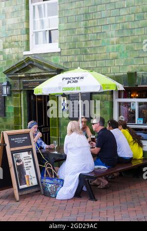 People having a drink outside The Poole Arms on the quayside at Poole Quay, Poole, Dorset UK on a warm sunny evening in July Stock Photo