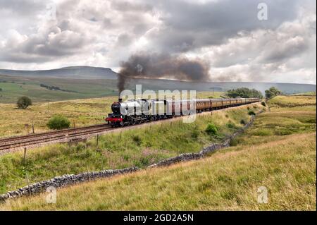 'The Pendle Dalesman' steam special from Lancaster to Carlisle, via the famous Settle-Carlisle railway line. The service is seen here storming up the gradient near Selside in Ribblesdale, en route to Carlisle. Pen-y-ghent peak is seen in the background. Credit: John Bentley/Alamy Live News Stock Photo