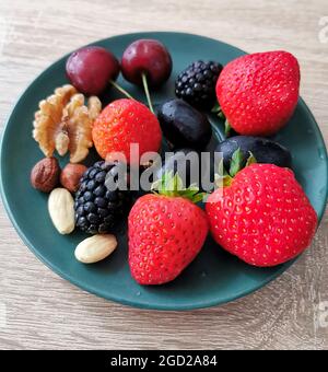 Fresh colorful berries and nuts are the best snack and dessert Stock Photo