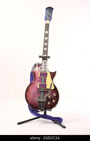 Vintage electric guitar on a stand isolated on a white background Stock Photo