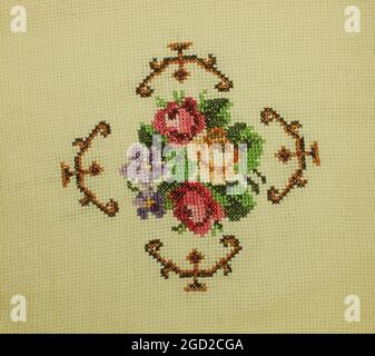 Cross stitch, hand embroidered, needle, Rose with leaves and border Stock Photo