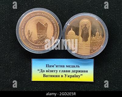 KYIV, UKRAINE - AUGUST 10, 2021 - The obverse and reverse of the To the Visit of the Head of the Vatican City State to Ukraine are pictured at the Min Stock Photo