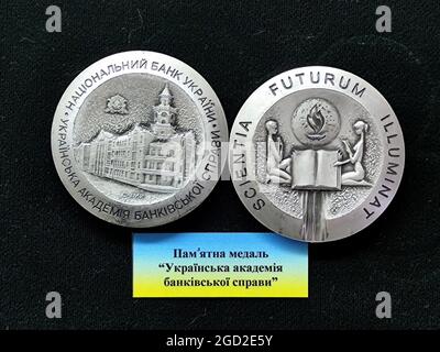 KYIV, UKRAINE - AUGUST 10, 2021 - The obverse and reverse of the Ukrainian Academy of Banking of the National Bank of Ukraine are pictured at the Mint Stock Photo