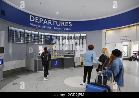 Newly refurbished entrance lobby at Victoria Coach Station, London, UK. Shows electronic departure board and information office. Stock Photo
