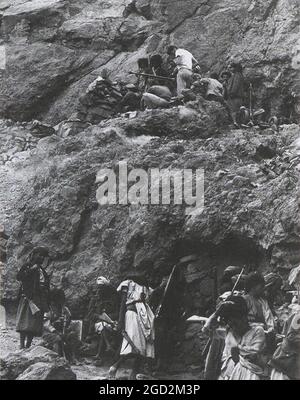 North Yemen: Two British mercenaries assist Yemeni royalist rebels set up a Russian heavy machine gun in the North Yemen Civil war of 1962-1967. Other rebels armed with .303 and other old rifles at bottom of photo Stock Photo