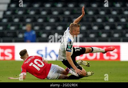 Derby County's Louie Sibley (right) battle for the ball Salford City's Ashley Hunter battle for the ball during the Carabao Cup first round match at Pride Park Stadium, Derby. Picture date: Tuesday August 10, 2021. Stock Photo