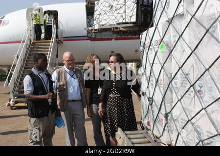 A USAID transport carrying 67 tons of humanitarian supplies arrives from Nairobi to South SudanA group headed by U.S. Ambassador to South Sudan, Susan Page, (far right) meet the emergency aid shipment as it arrives in Juba ca. 4 February 2014 Stock Photo