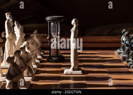 Queen confronting king and its army in chess board scene. Stock Photo